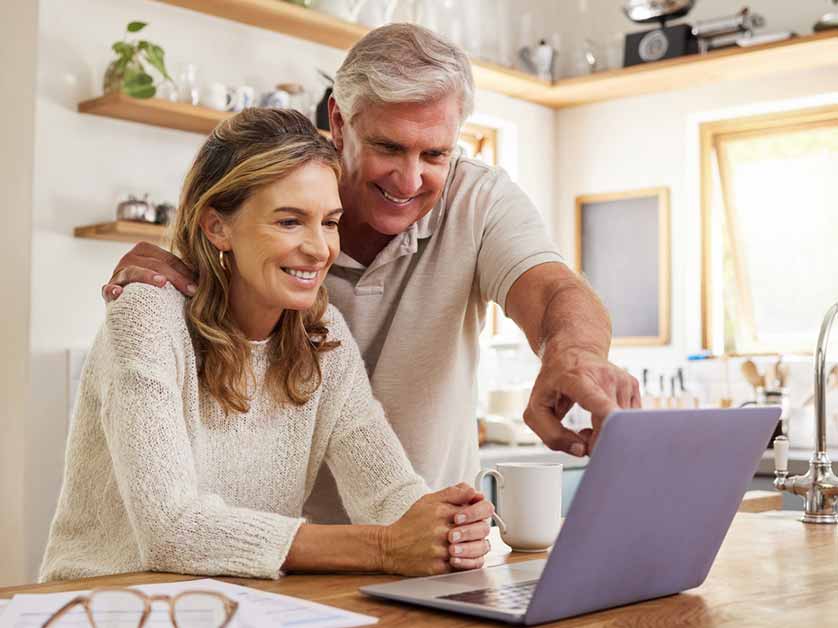 One male & female senior citizen looking at the laptop's screen and discussing things in Gresham, OR